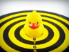 Yellow plastic duck on black and yellow bullseye